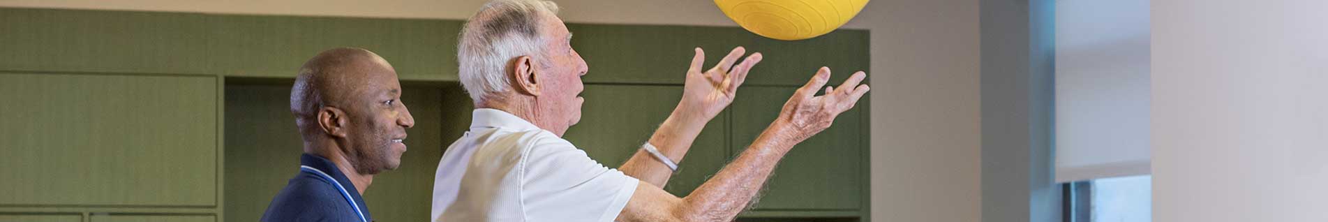 resident with a staff member exercising
