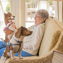 resident with her dogs sitting in her room